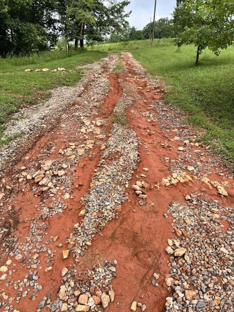 a driveway with huge ruts in it
