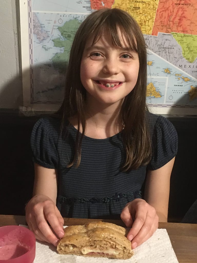 Girl eating stromboli