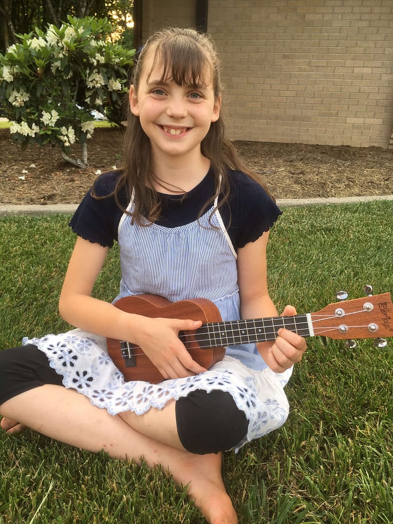 Makenna Holladay playing the ukulele age 11