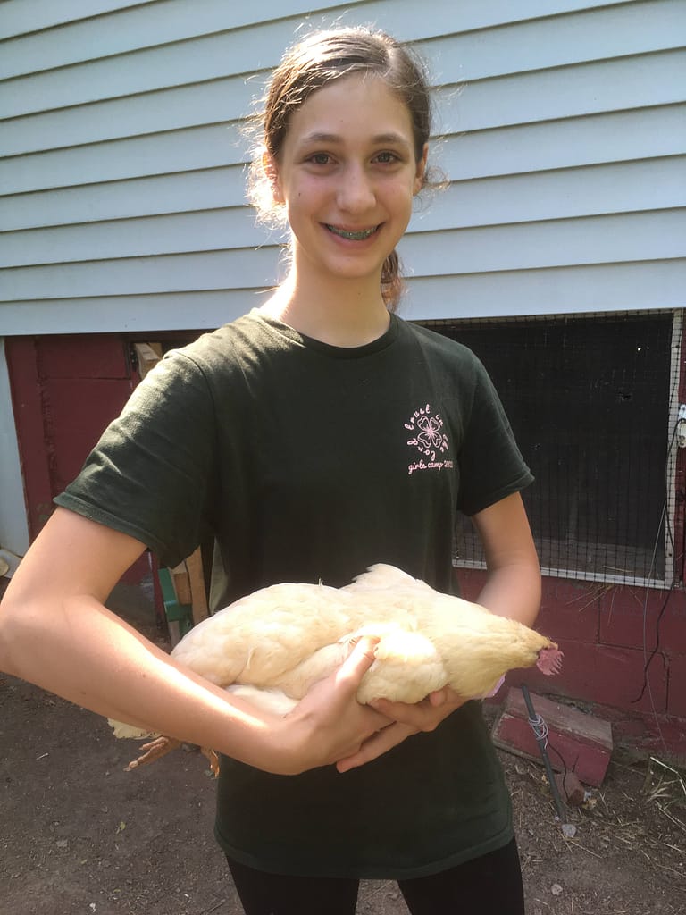 3 year old girl holds her dead chicken