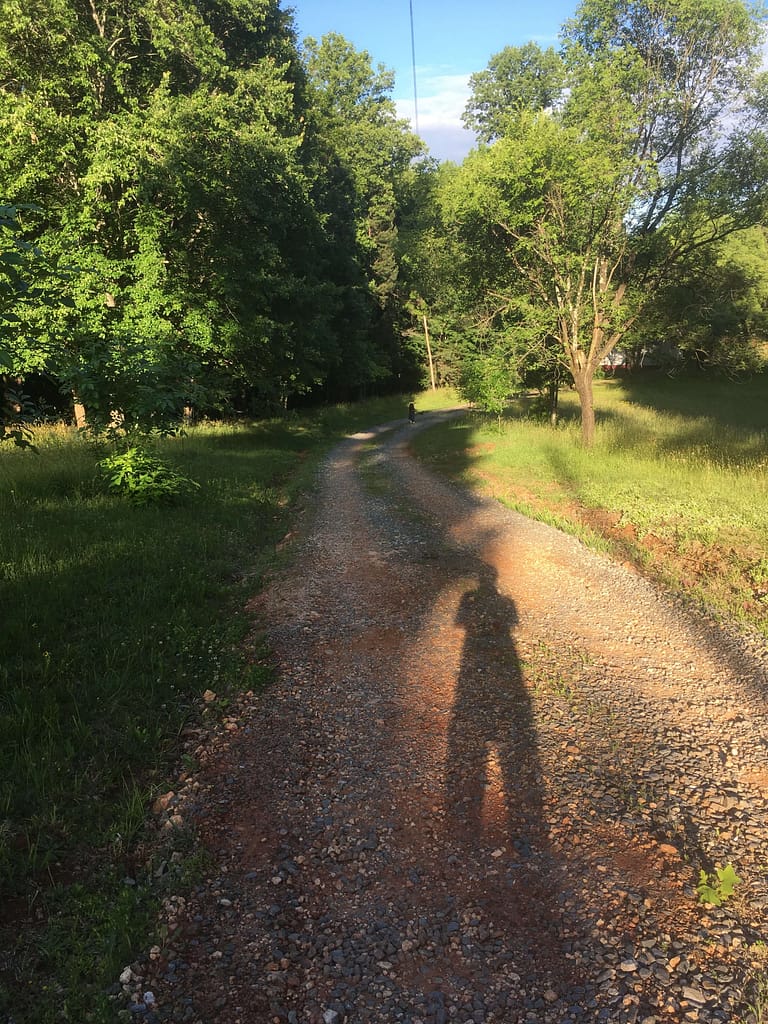 girl walking down a dirt road