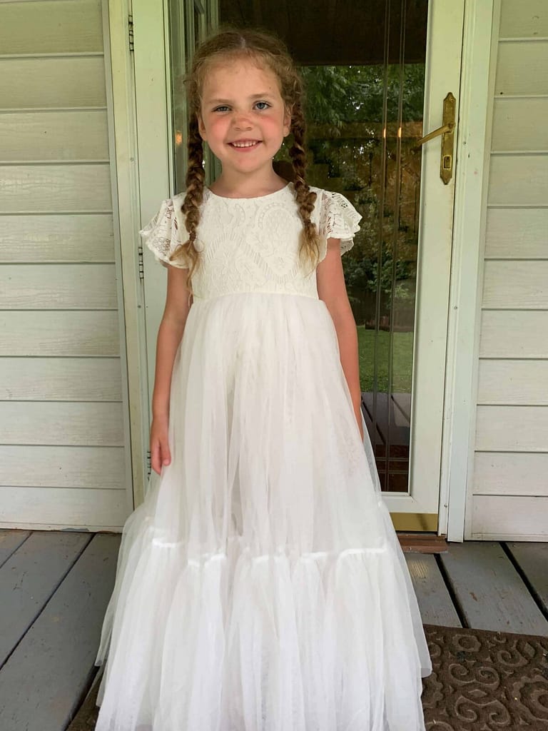 6 year old in a long white poufy dress