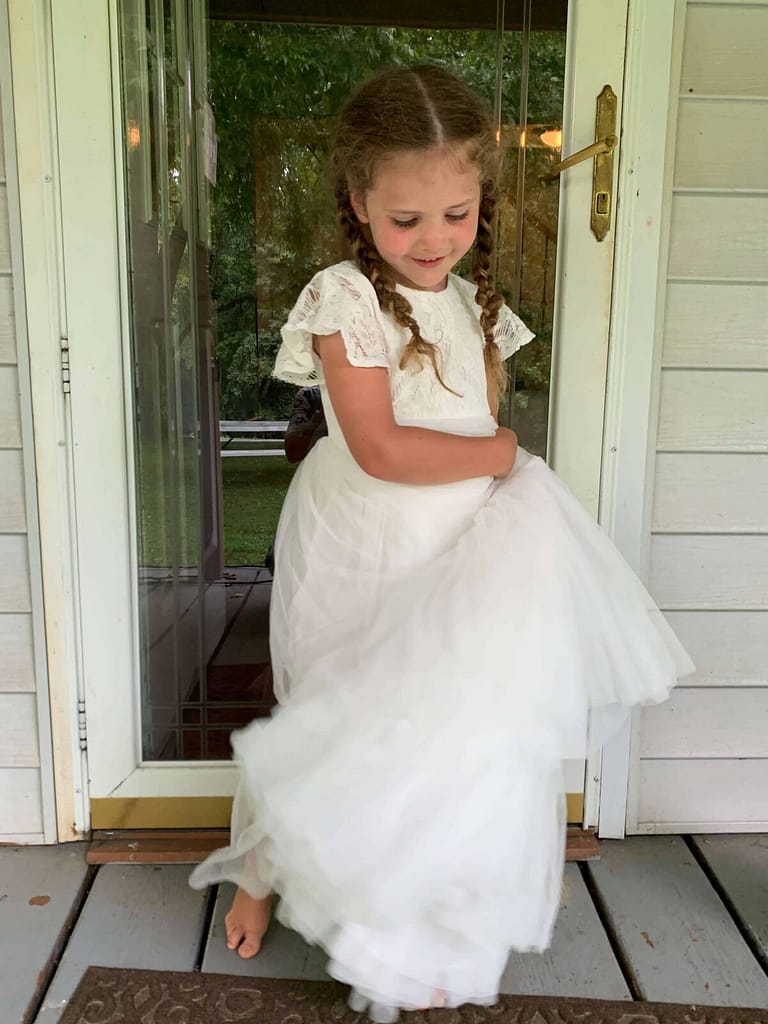 little girl twirling in a poufy white dress