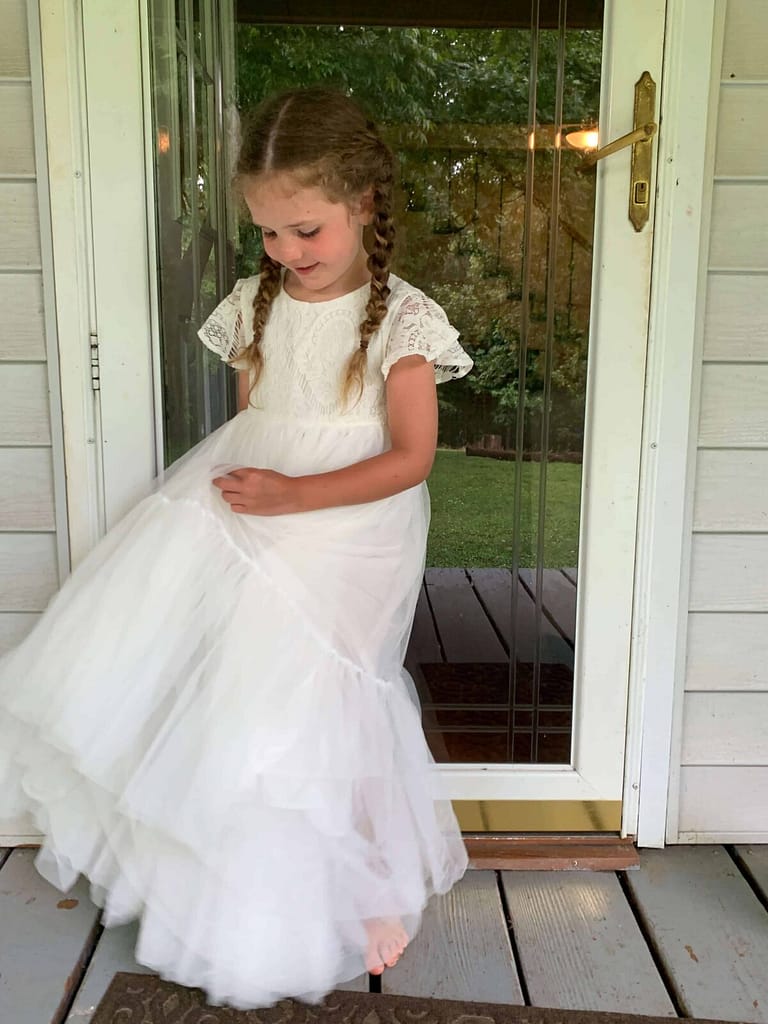 little girl swirling in a white dress
