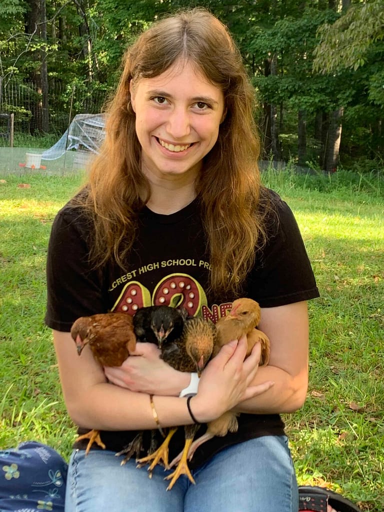 teenager holding 4 little pullets