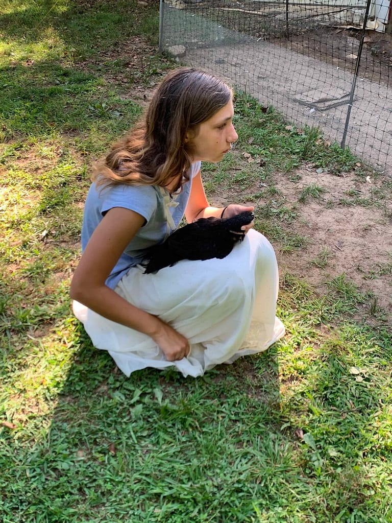 teenager crying over a dead pet chicken