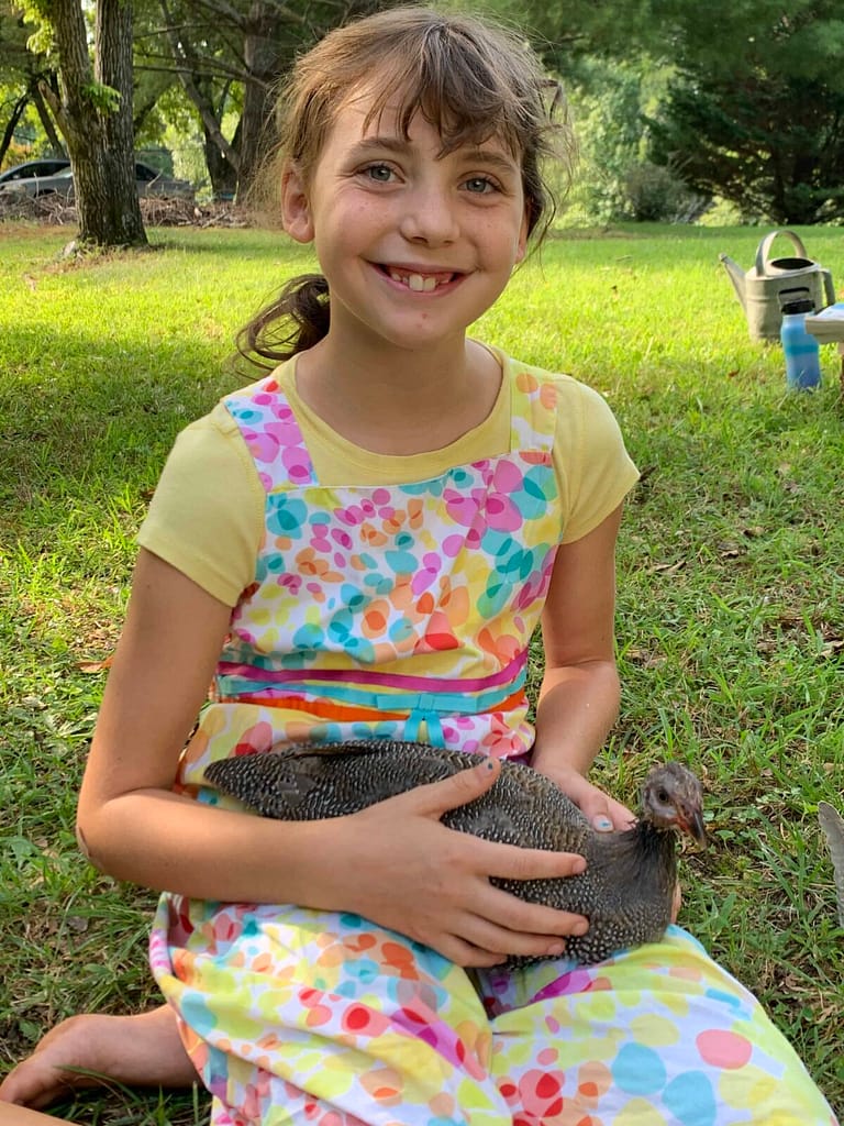 11 year old girl holding a guinea fowl