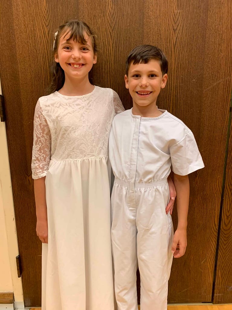 two kids at a baptism