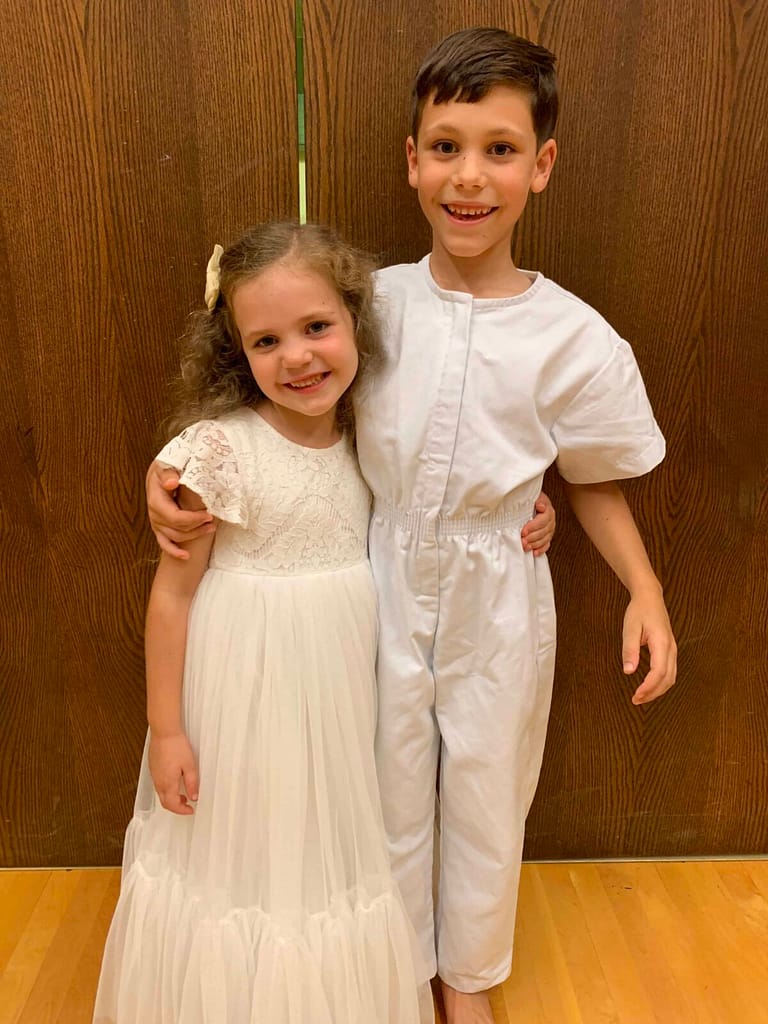 two siblings at a baptism
