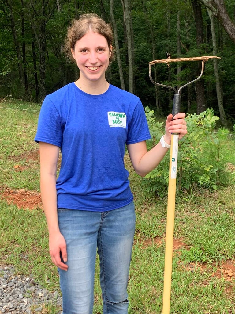 girl holding a rake