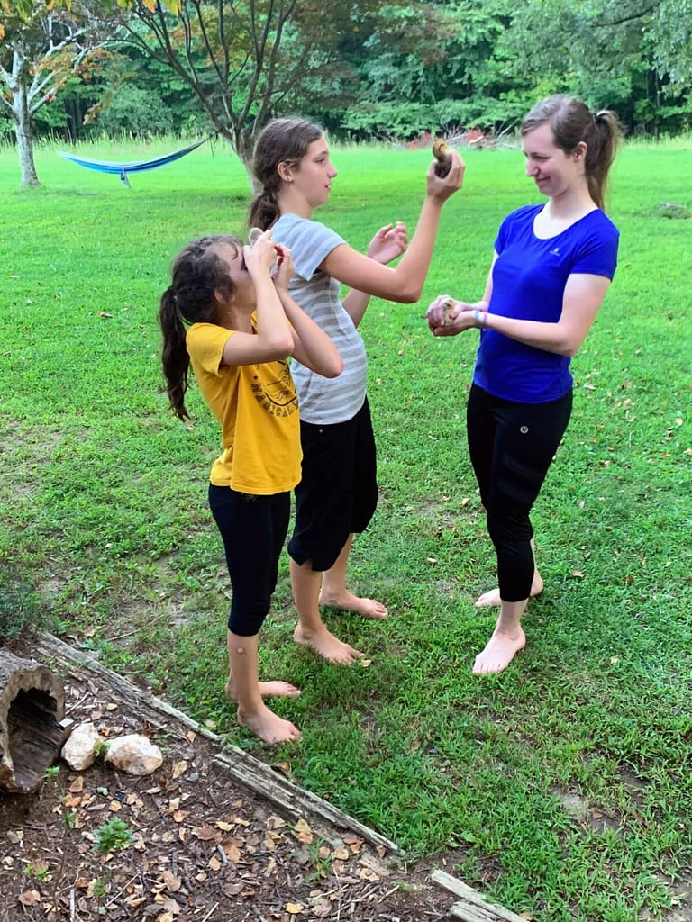 3 sisters playing with baby chicks