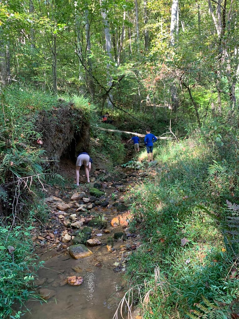 boys playing in a rocky creek