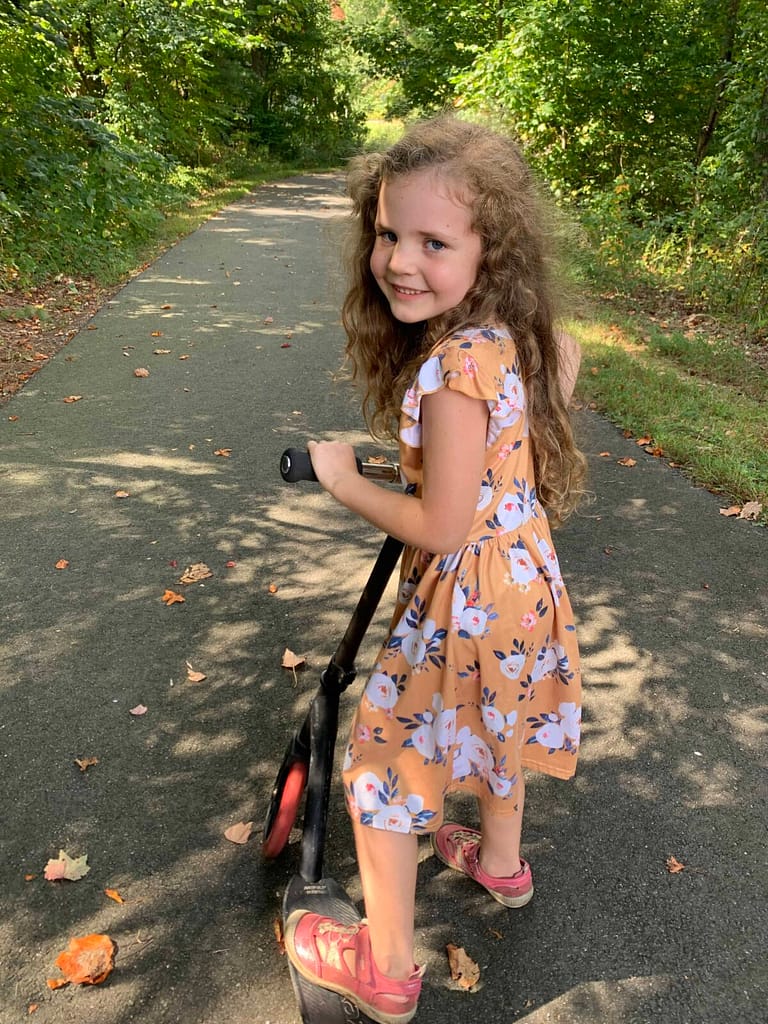 6 year old riding a scooter on a warm fall day