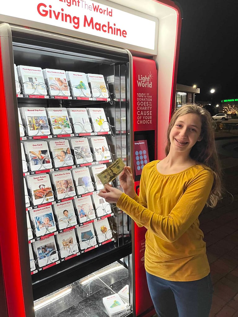 girl donating to the giving machine