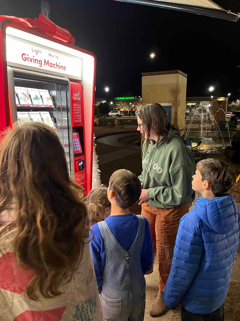 kids donating to light the world giving machine