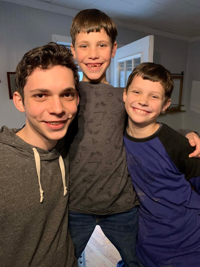 3 brothers smiling into the camera