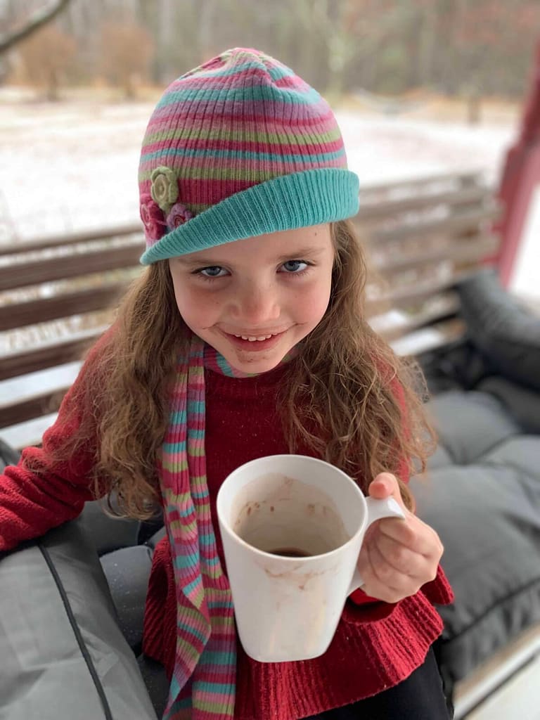 adorable girl drinking raw milk hot chocolate