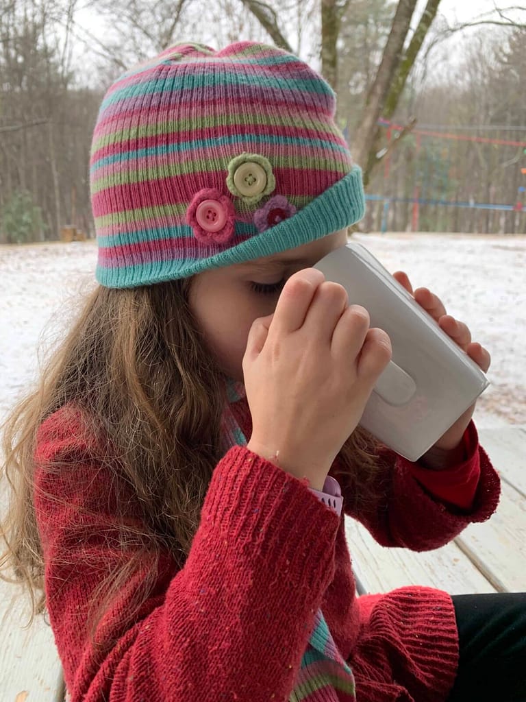6 year old drinking a mug of raw milk hot cocoa