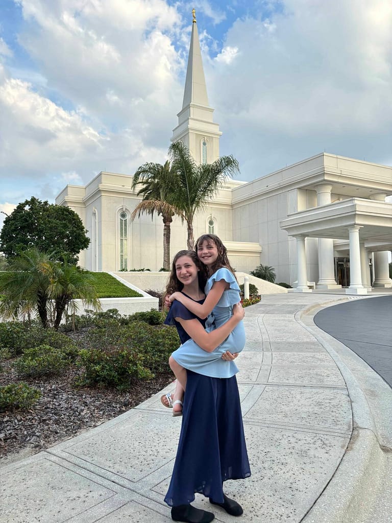 sisters posing in front of the Orlando temple