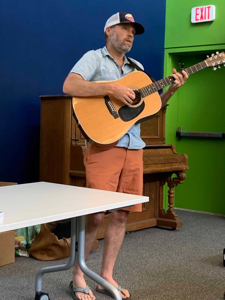 Brew Davis playing his guitar