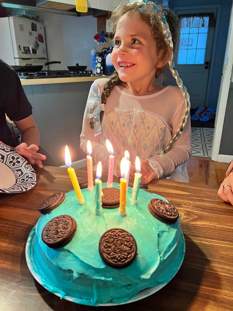 7 year old smiling as she gets sung happy birthday to