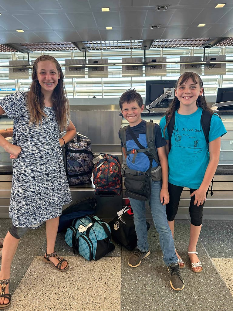 3 kids at the airport