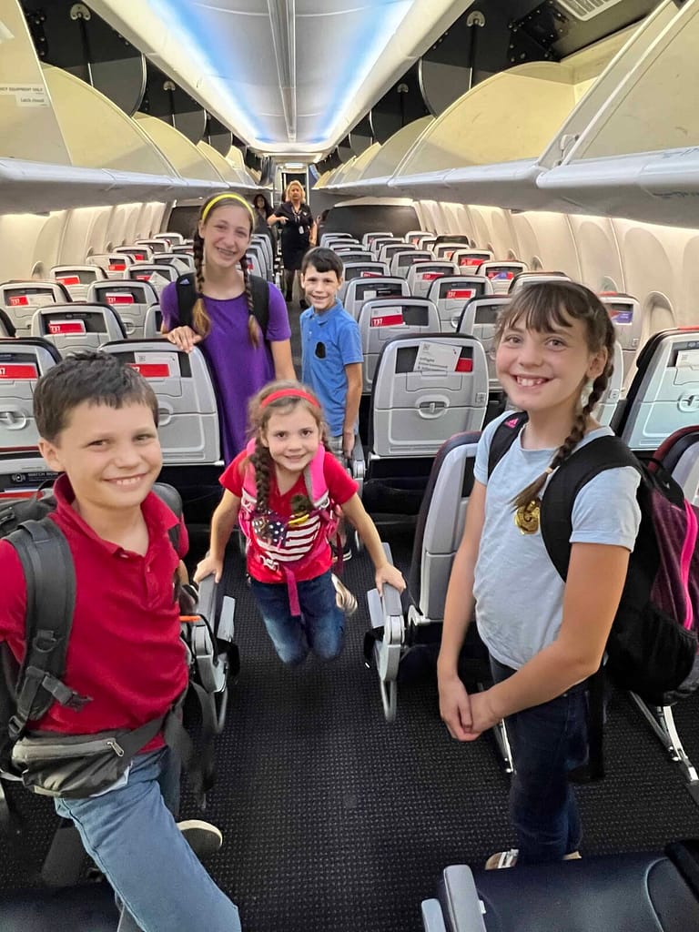 5 kids on an empty airplane