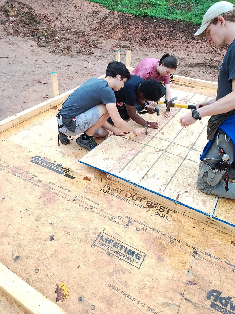 youth helping with a habitat humanity build