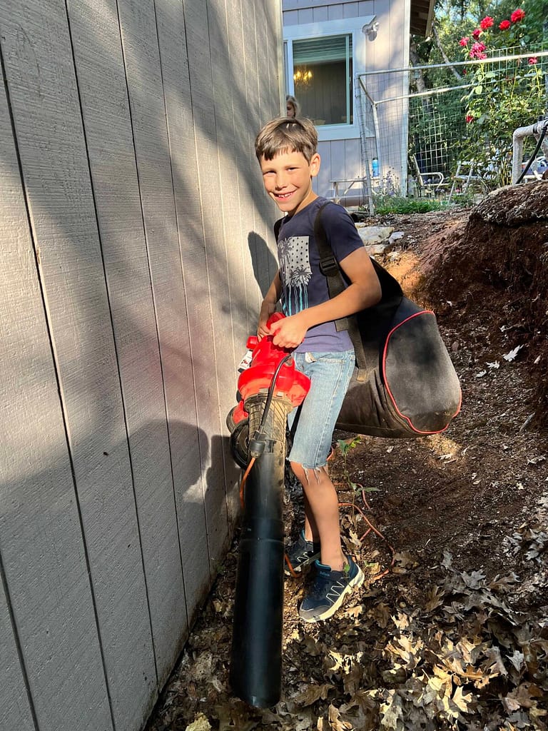 boy sucking leaves in a machine