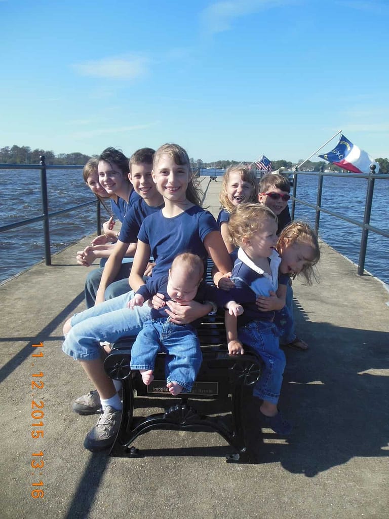 9 siblings on a bench in Edenton pier, NC