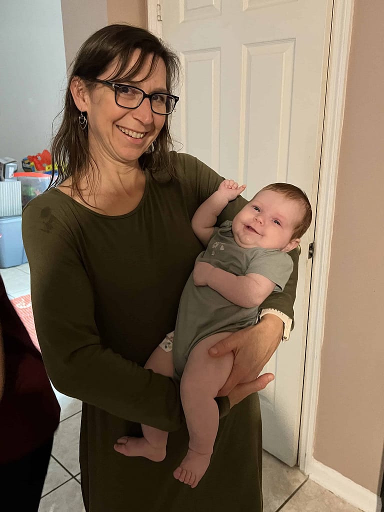 mom holding 2 month baby girl