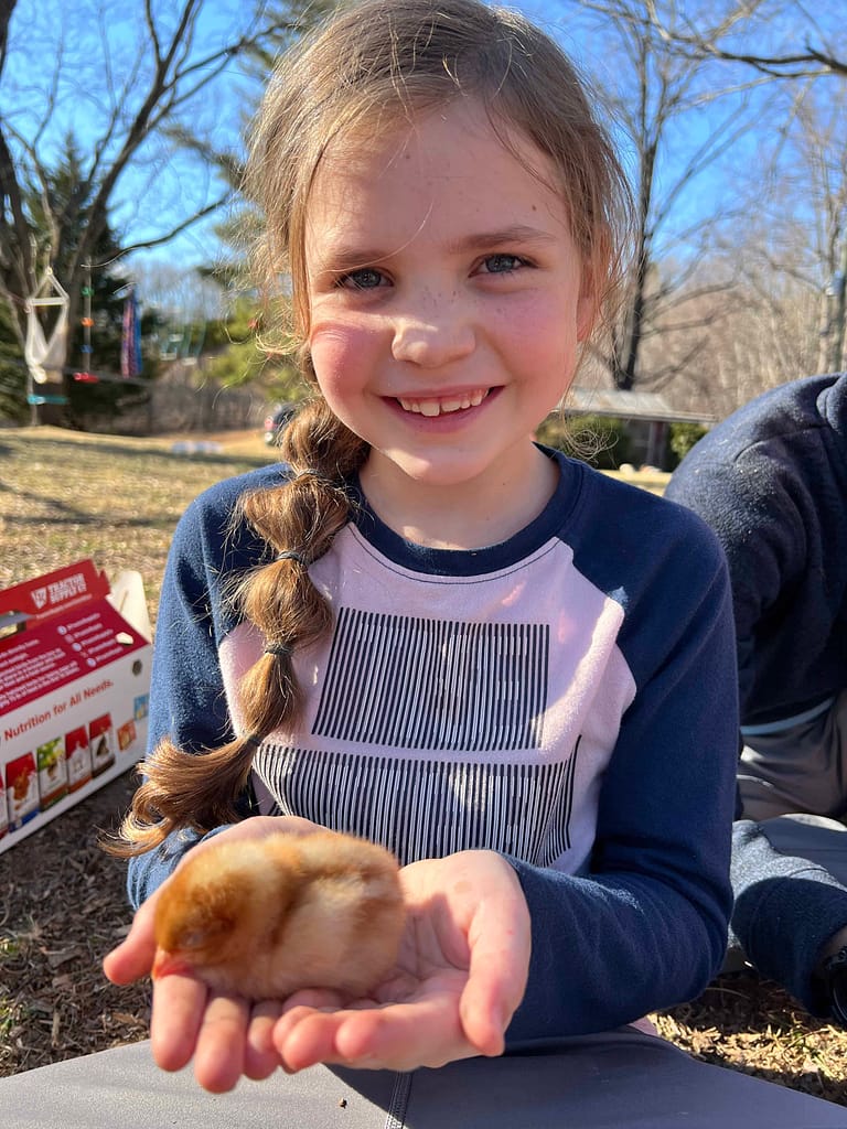 7 year old holding chick