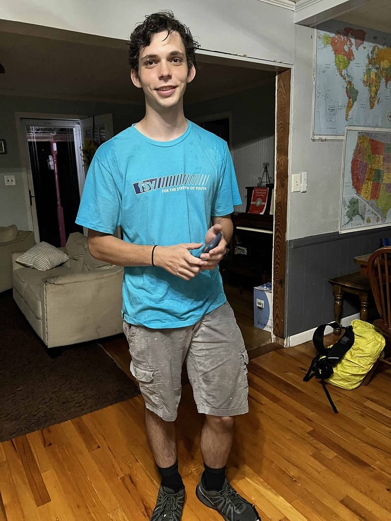 teen boy coming home wet from the rain