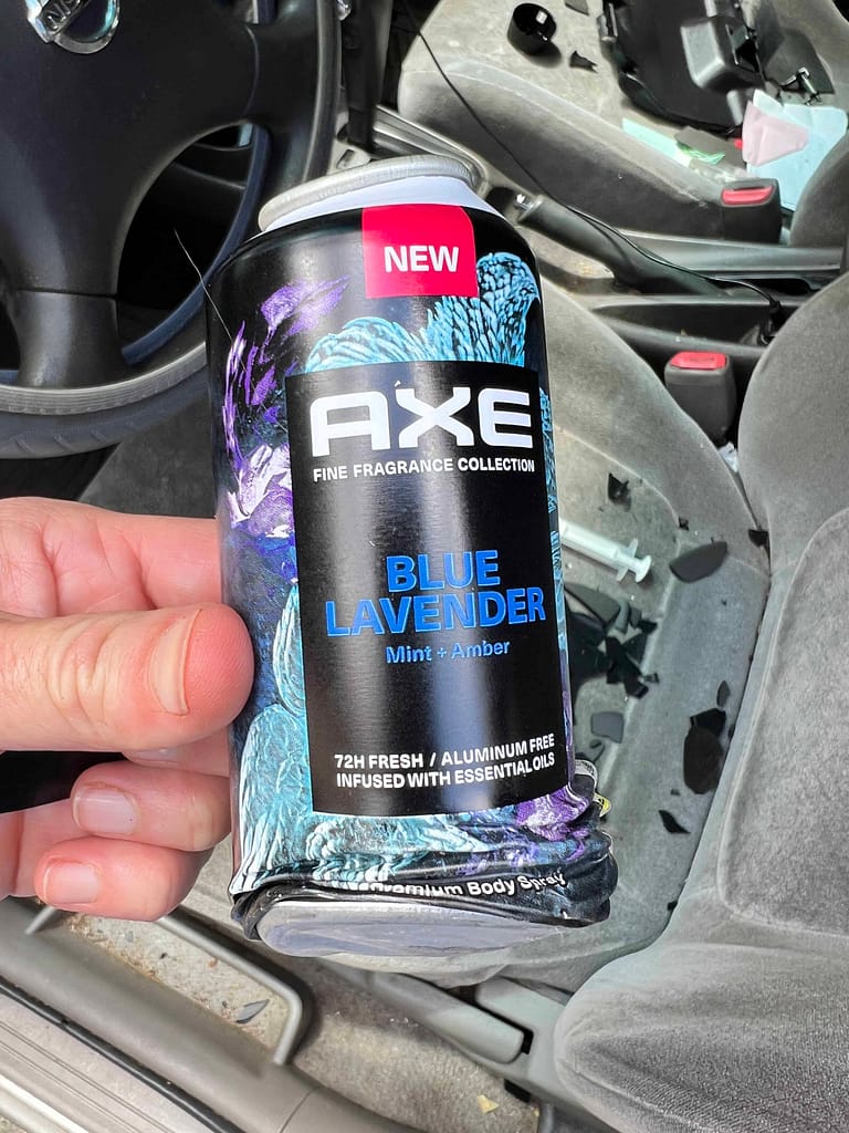 smashed aerosol can of cologne