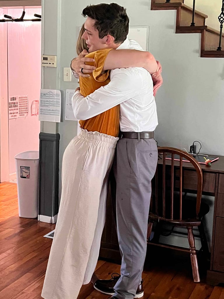 brother and sister hugging goodbye