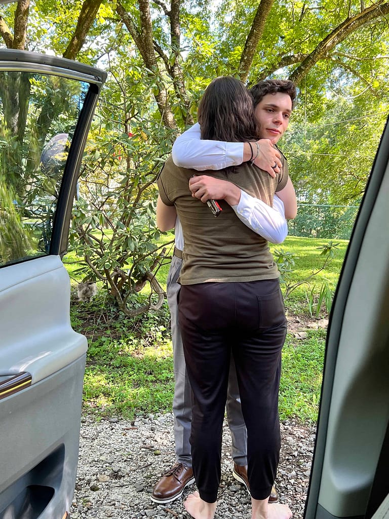 teen brother and sister hugging goodbye