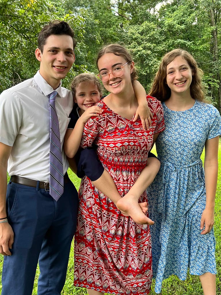 family of 4 kids, one riding piggy back