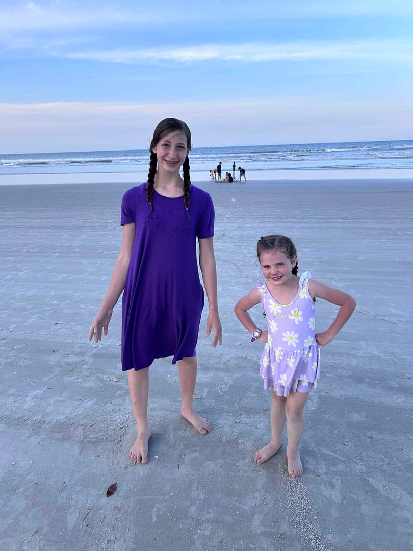 13 year old and 6 year old at the beach