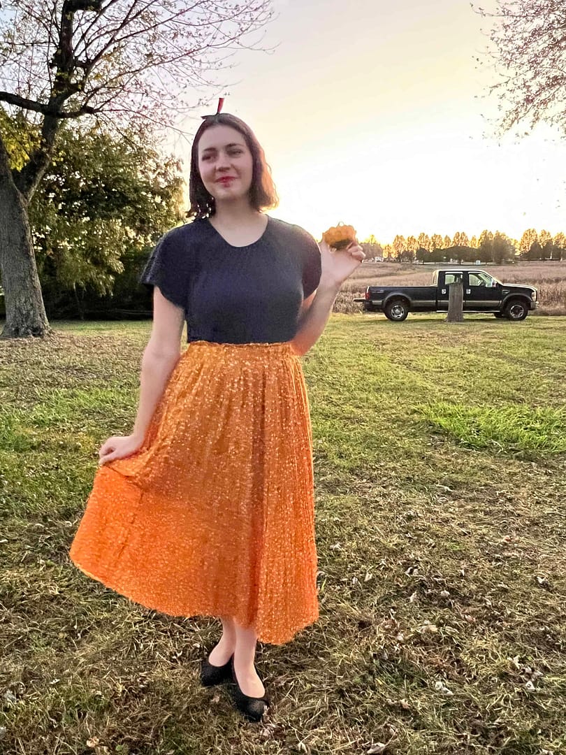 Woman dressed up as Snow White holding a gourd
