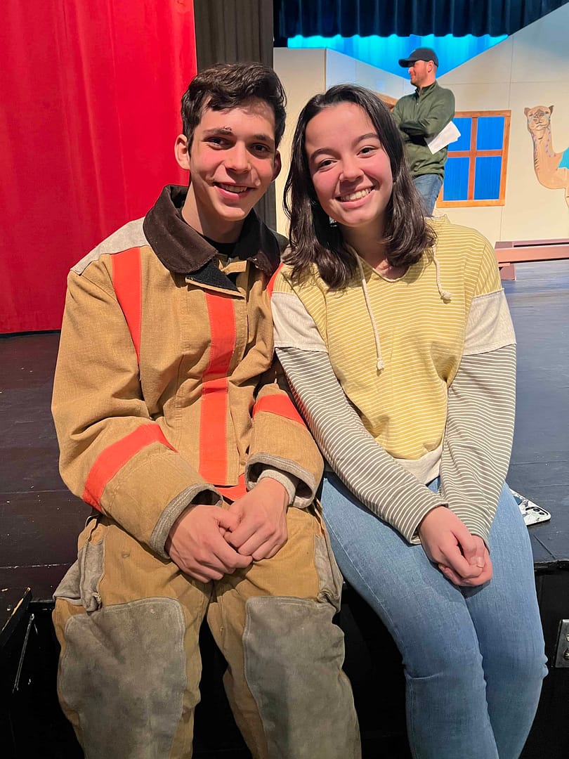 boy in firefighter costume with a girl next to him
