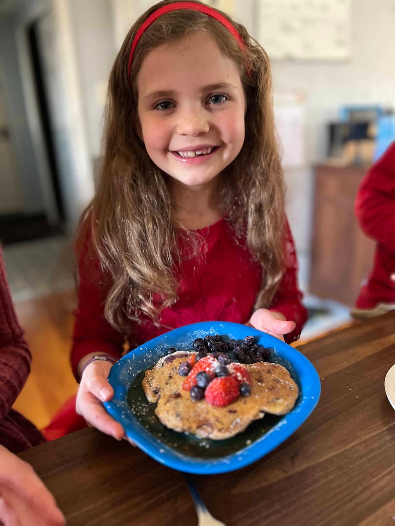 7 year old eating heart shaped pancakes for lunch