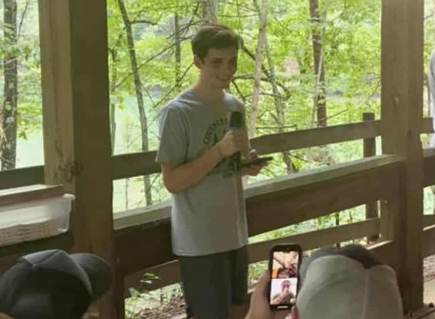 boy talking into microphone at camp