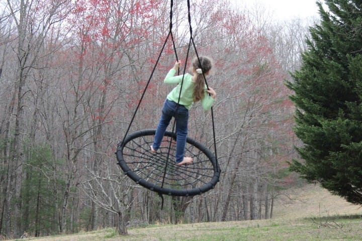 girl on spiderweb swing