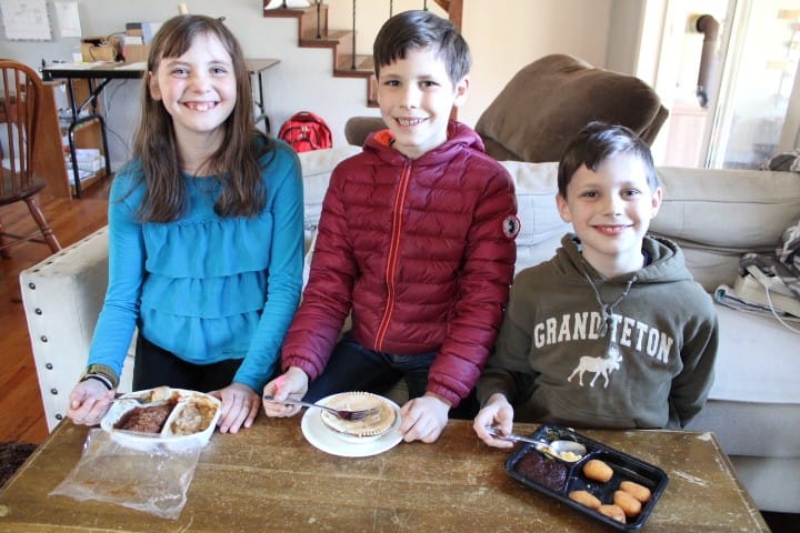 3 kids eating TV dinners
