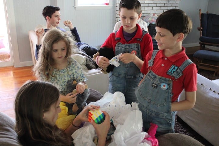 13 year old opens presents with her siblings surrounding her