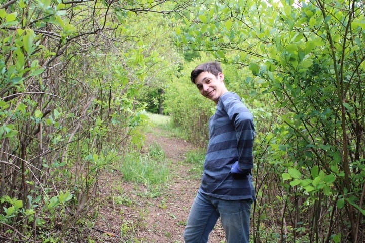 15 year old boy making a cool move while working in a blueberry patch