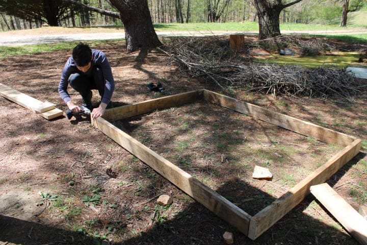 Boy makes a raised garden bed