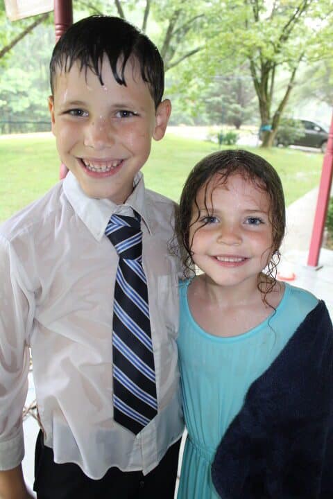 brother and sister wet from the rain