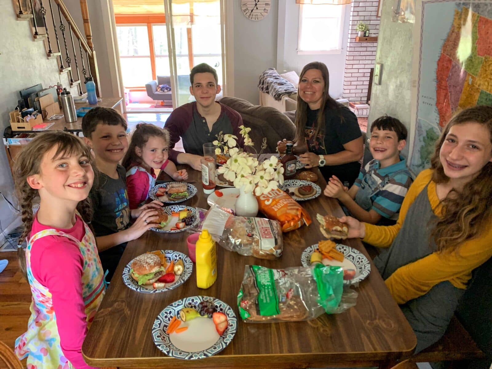 Family eating hamburger lunch around the table