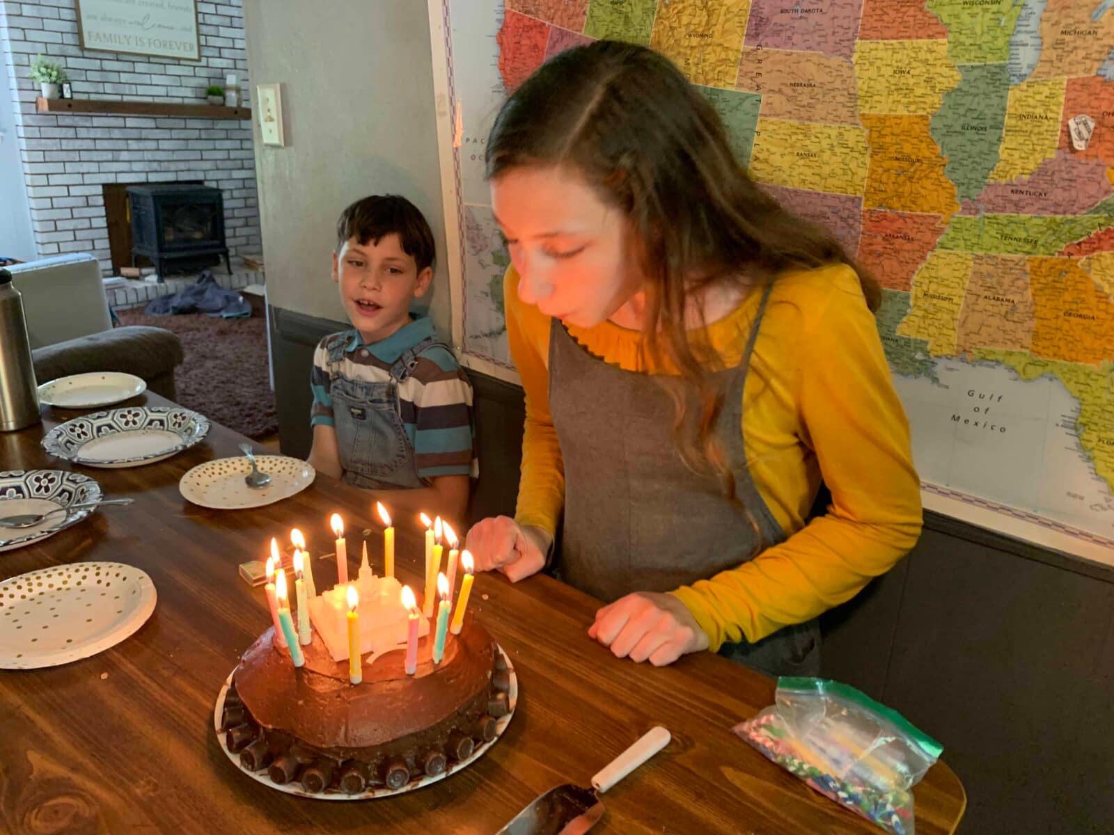 teen girl blowing out birthday candles